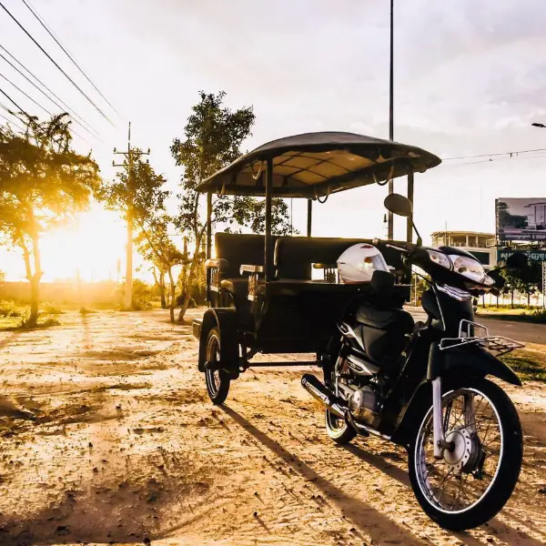 Traditional Cambodian tuk-tuk ( remork ) on a busy street.